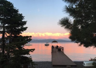 Photo of the dock at sunset surrounded by trees