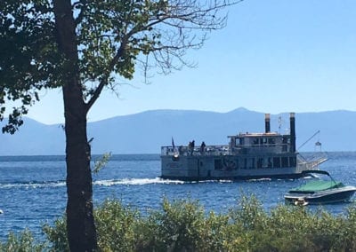 Photo of a steam boat and motor boat on Lake Tahoe