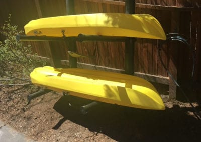 Photo of a kayak rack with yellow kayaks